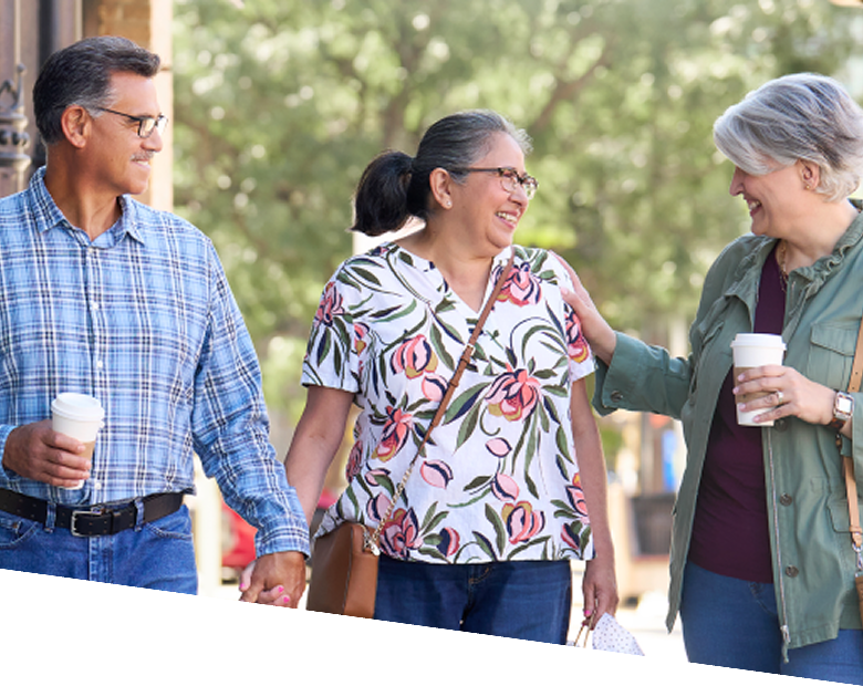 Three adults walking outdoors