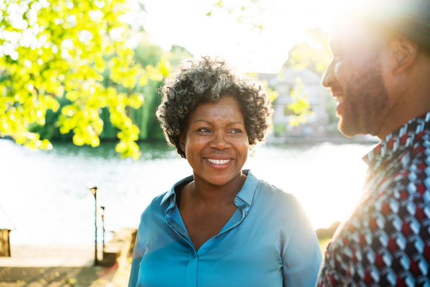 A couple walking outside near a body of water