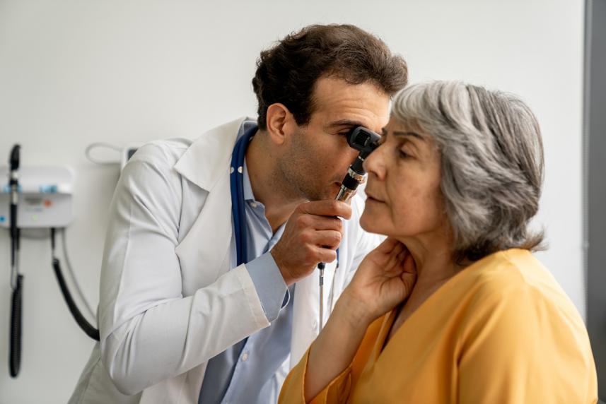 A doctor checking a patients ear