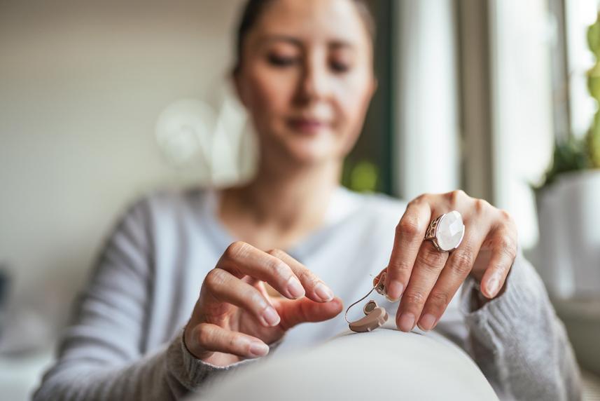 Woman holding a hearing aid