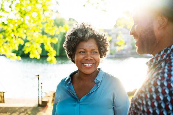 A couple walking outside near a body of water